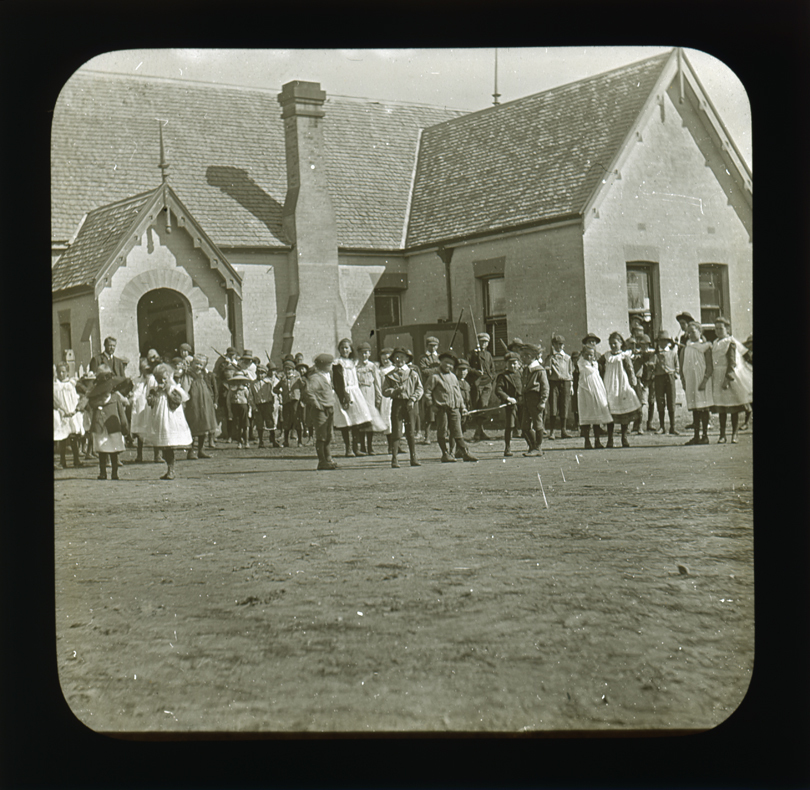 Children gathered in front of unidentified school building [Hawkesbury Agricultural College (HAC)]