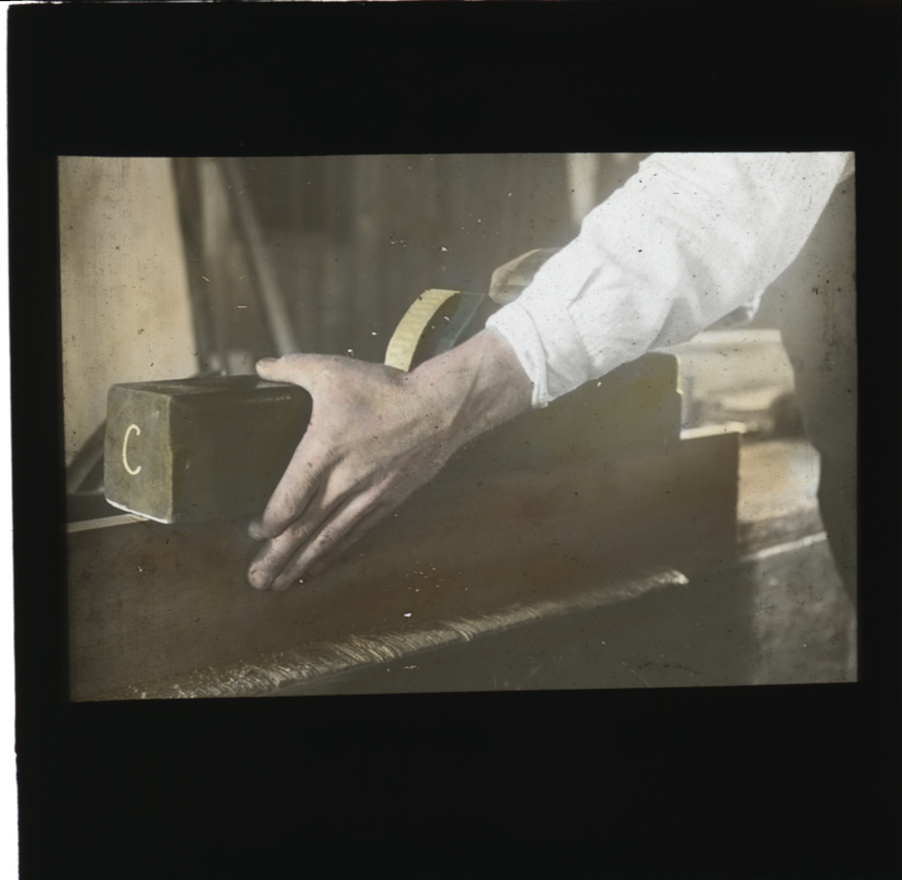 Woodworking - hands holding and using a wooden hand plane [Hawkesbury Agricultural College (HAC)]