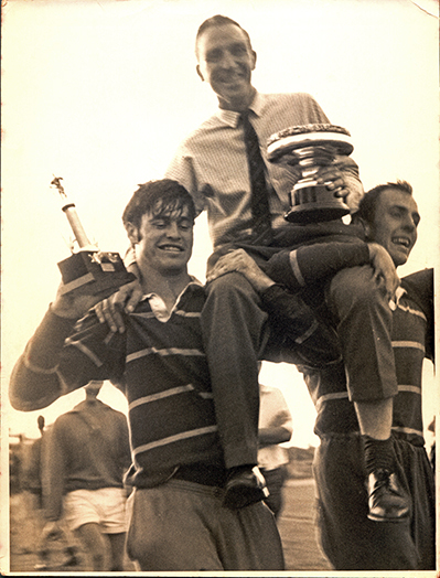 Two rugby players holding Colin Levick (Coach) aloft - 1970's
