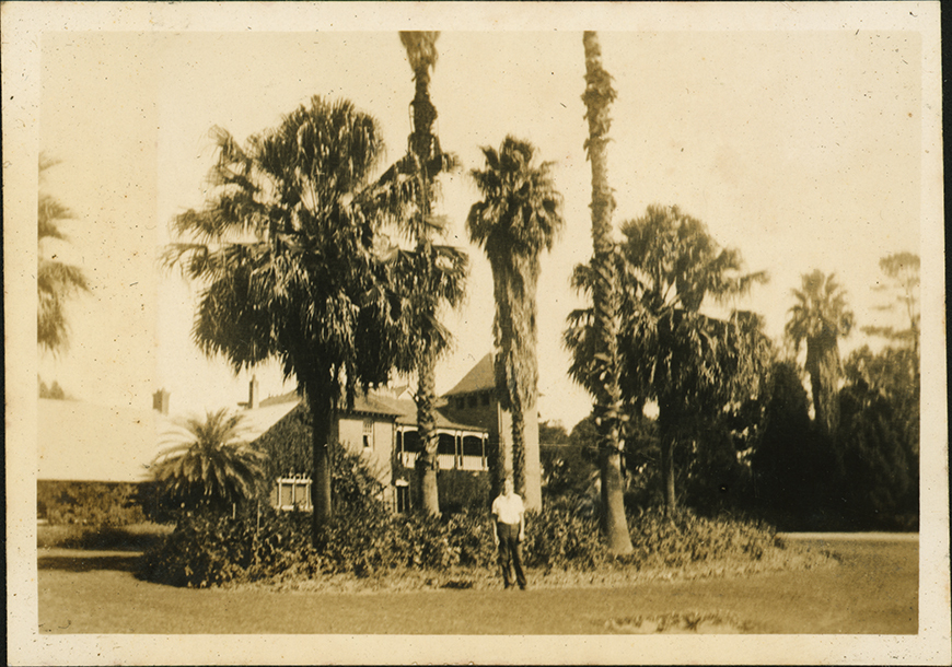 Fairy Circle and Administration Building (student standing in the Fairy Circle) - Apr 1936 [Hawkesbury Agricultural College (HAC)]