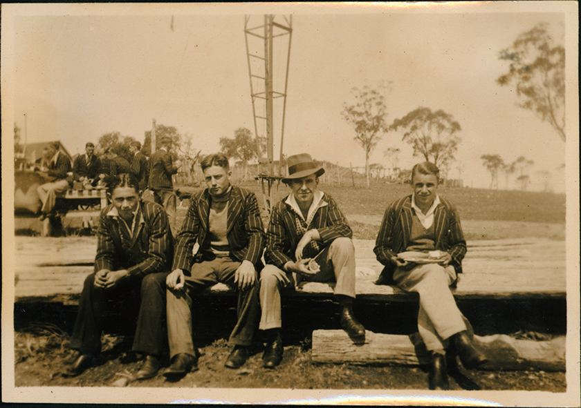 Students seated on a log