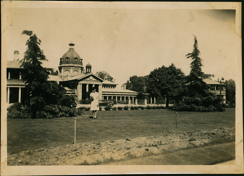 Woman standing in front of grand building