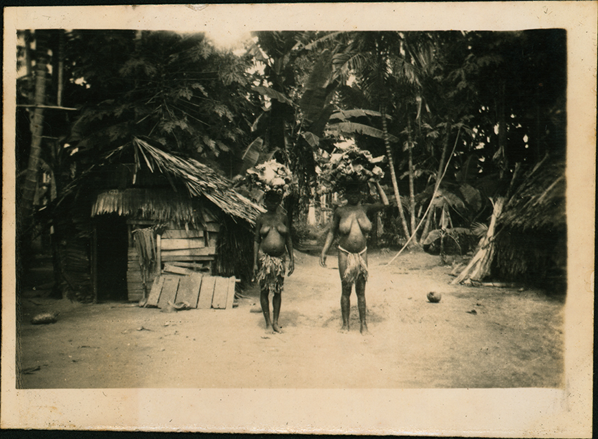 Native Women bearing loads on their heads - Cassia Village (near Hoskins Airfield, New Britain Island, Papua New Guinea)