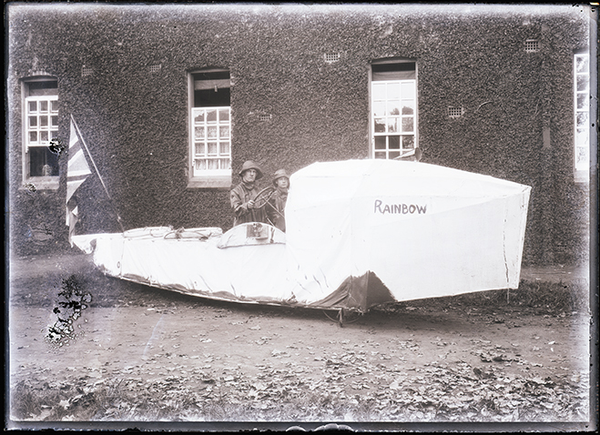 Empire Day - Students dressed up - Two students on a boat named Rainbow and flying the Union Jack [Hawkesbury Agricultural College (HAC)]
