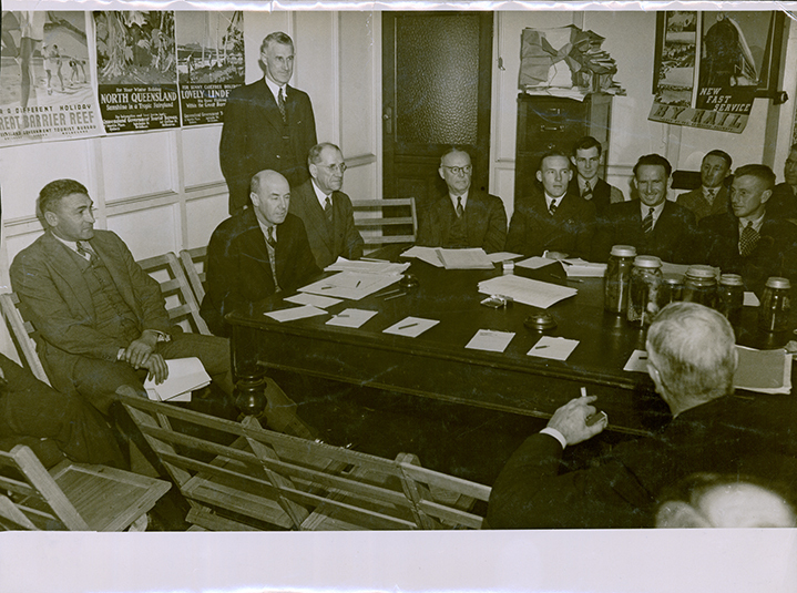 Group of men in suits around a table