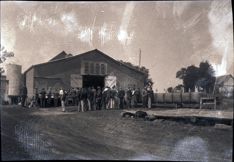 Large group of student outside a shed