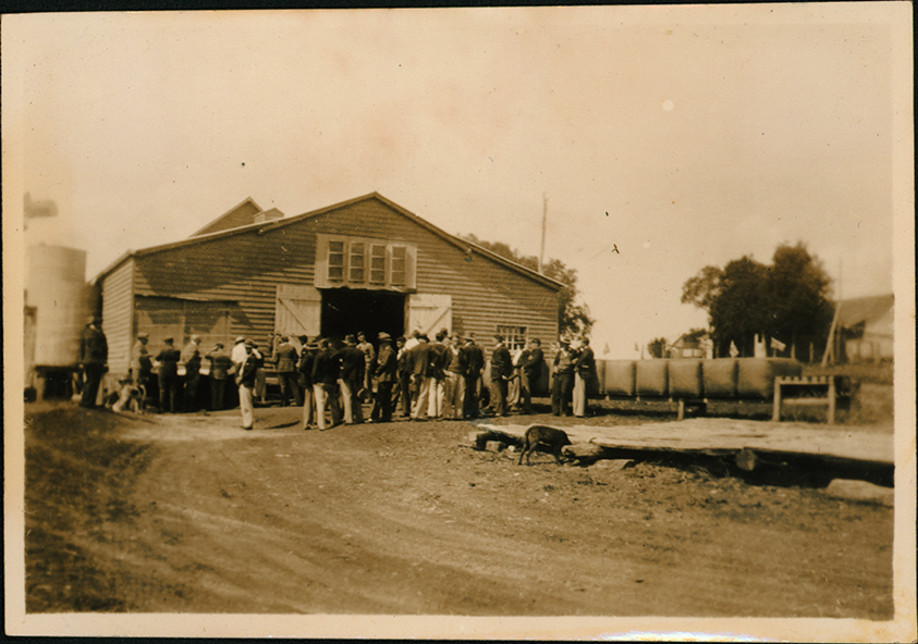 Large group of students outside a shed