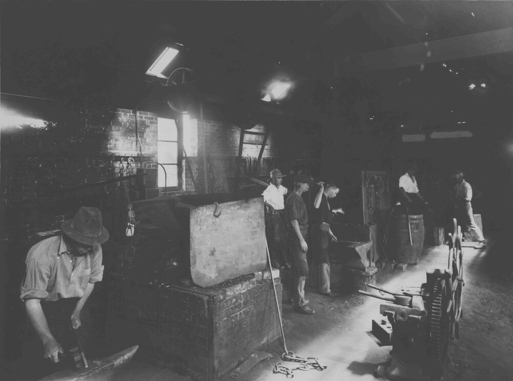 Blacksmith Shop (interior) - Blacksmith DH Reay overseeing work [Hawkesbury Agricultural College (HAC)]