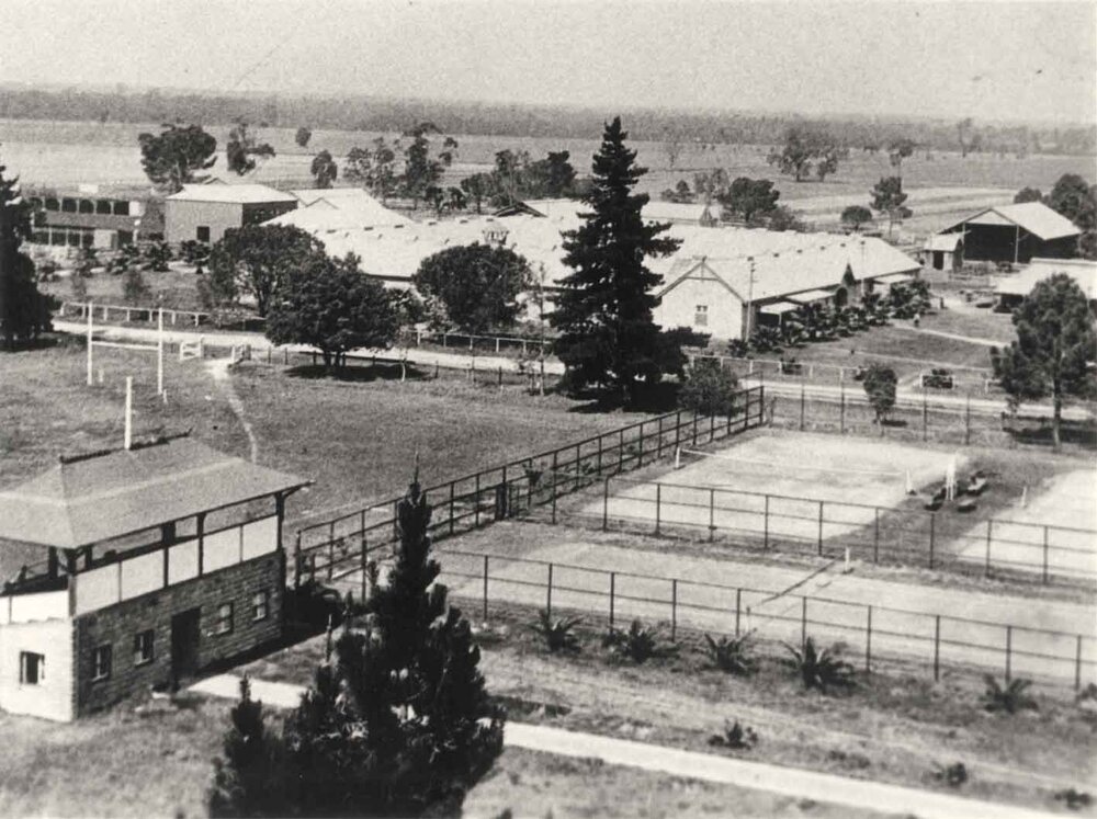 Sports pavilion (grandstand) and tennis courts with Stable Square in background - Print 2 of 2 (cropped) [Hawkesbury Agricultural College (HAC)]