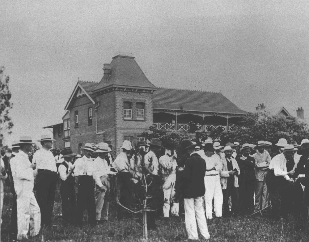 Winter School for Farmers, 1906 - student farmers observing a demonstration from the horticulture lecturer at the Shrubbery, near the Fairy Circle [Hawkesbury Agricultural College (HAC)]