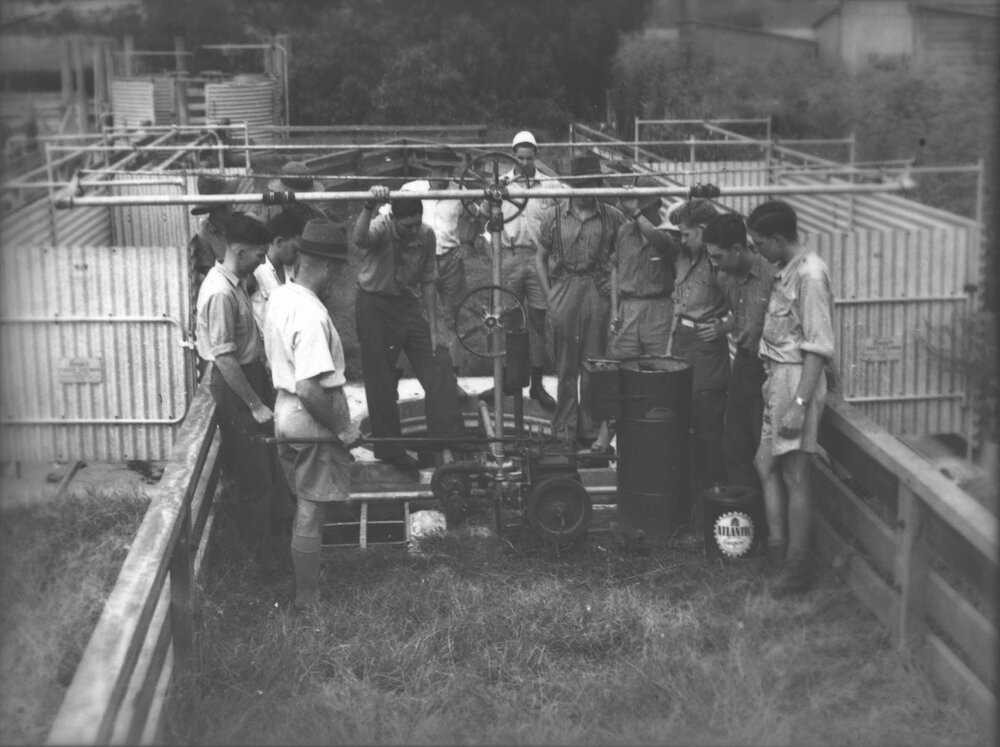 A group of staff and students inspecting a piece of machinery [Hawkesbury Agricultural College (HAC)]
