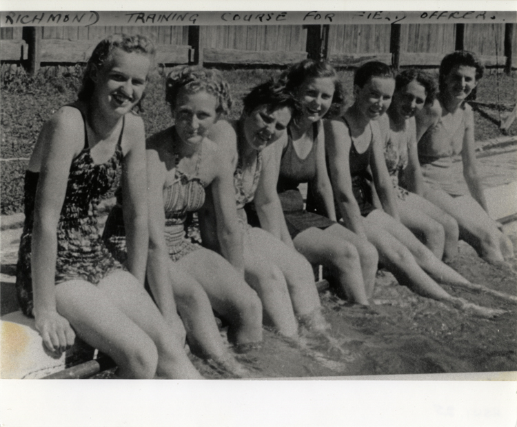 Women's Land Army: Several women sitting on the edge of the swimming pool [Hawkesbury Agricultural College (HAC)]
