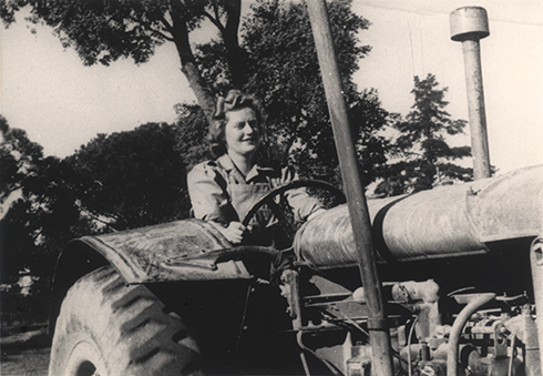 Women's Land Army: Faming activities (print 12 of 12) - Woman driving a tractor [Hawkesbury Agricultural College (HAC)]