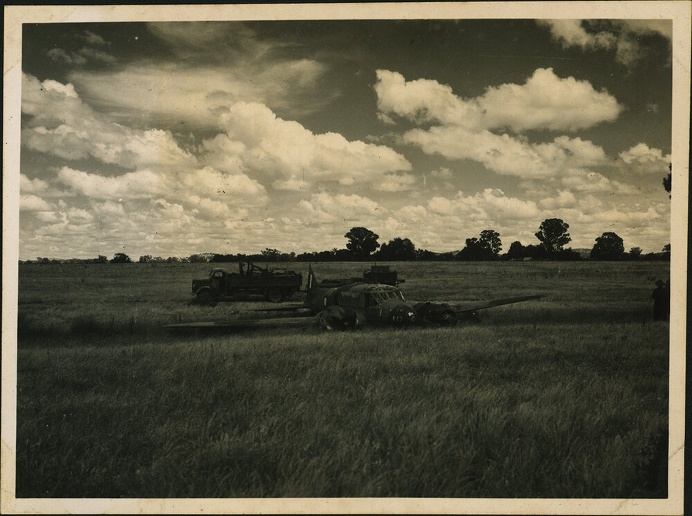 Aeroplane (A4 Avro Anson) in a field (Hoskins Airfield, New Britain Island, Papua New Guinea)