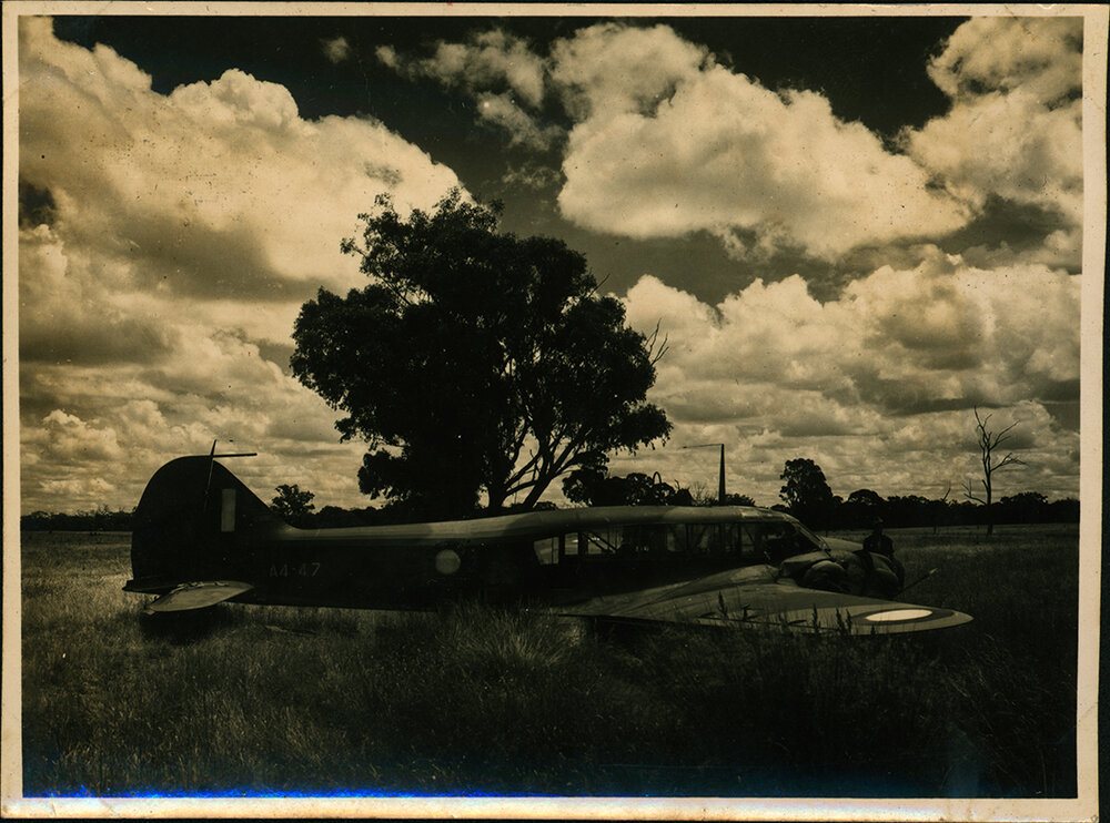 Aeroplane (A4 Avro Anson) in a field (Hoskins Airfield, New Britain Island, Papua New Guinea)