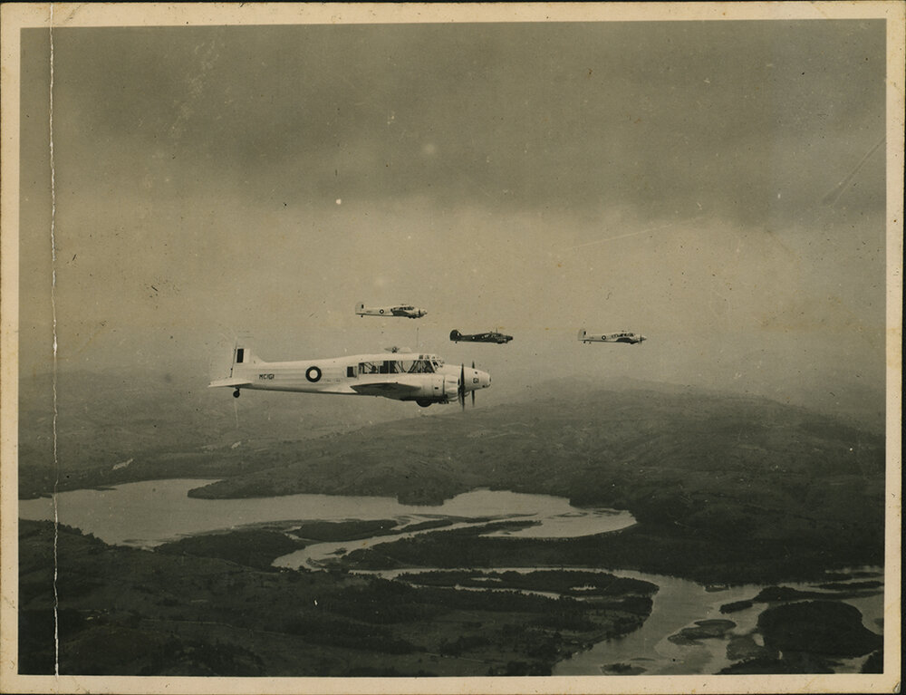 Aerial Photograph - Four A4 Avro Anson planes flying over a river