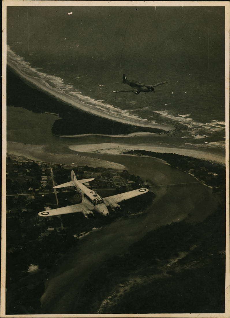 Aerial Photograph - Two A4 Avro Anson planes flying over a river