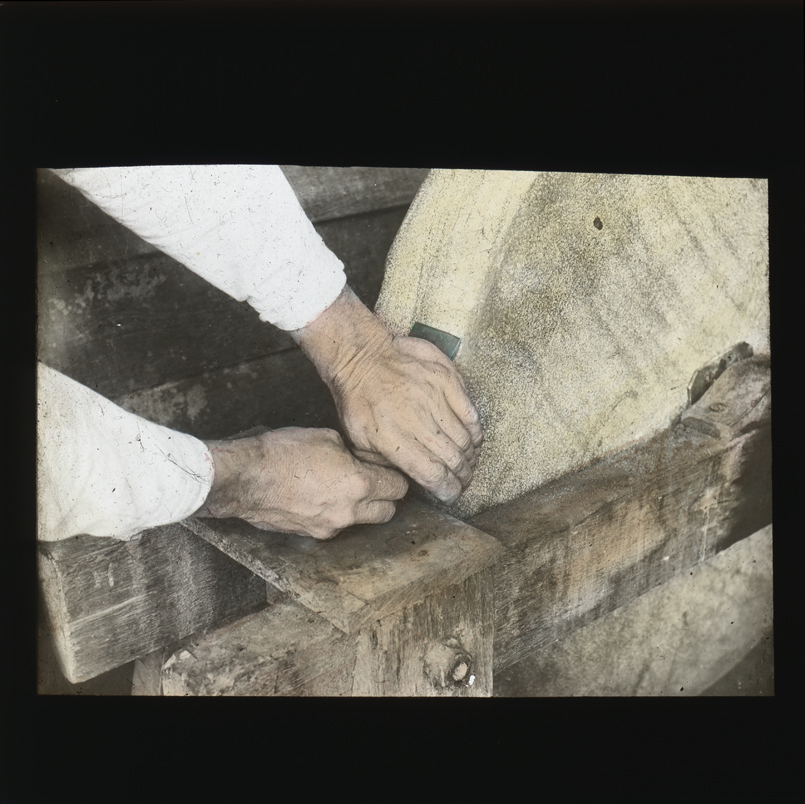 'Axe to the grindstone'. Image of sharpening an axe head using a grindstone [Hawkesbury Agricultural College (HAC)]