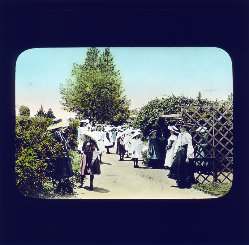 School students standing in a garden area talking [Hawkesbury Agricultural College (HAC)]
