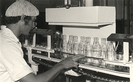 Dairy Factory (interior): student checking clean milk bottles (Print 2 of 2) [Hawkesbury Agricultural College (HAC)]