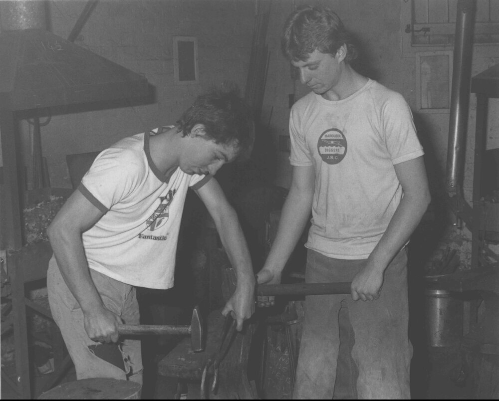 Blacksmith Shop (interior) - Two students working at an anvil [Hawkesbury Agricultural College (HAC)]