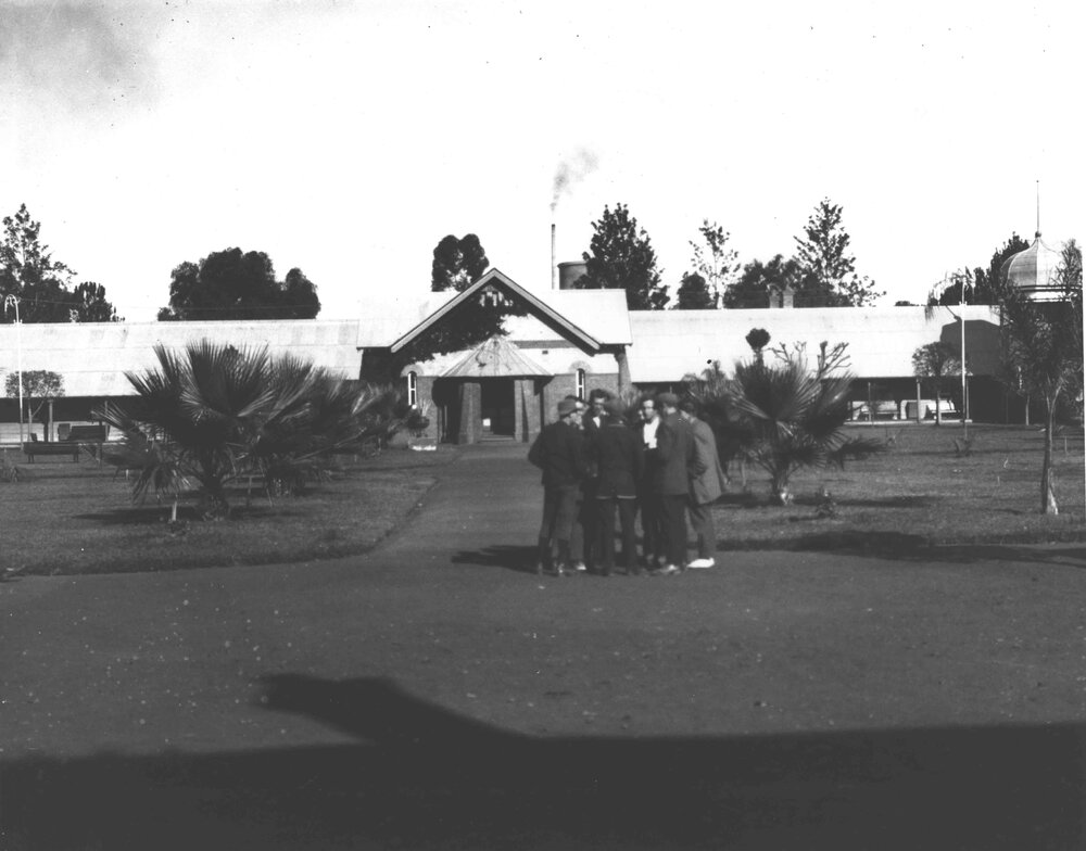 Students standing in the Quadrangle with the Dining Hall in the background [Hawkesbury Agricultural College (HAC)]