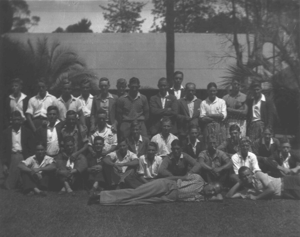 Students in casual dress, on a lawn outside a building (unidentified) [Hawkesbury Agricultural College (HAC)]