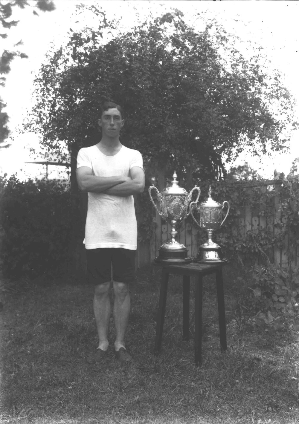 Student, G McGillivray, champion athlete, standing next to the trophies he won [Hawkesbury Agricultural College (HAC)]