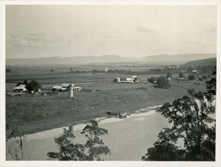 Beehives on River Farm (photograph taken from across the Hawkesbury river), mountain range in the distance [Hawkesbury Agricultural College (HAC)]