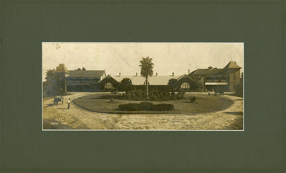 Framed photograph of front view of Hawkesbury Agricultural College (Old Administration Building with Fairy Circle in foreground) Circa 1917.