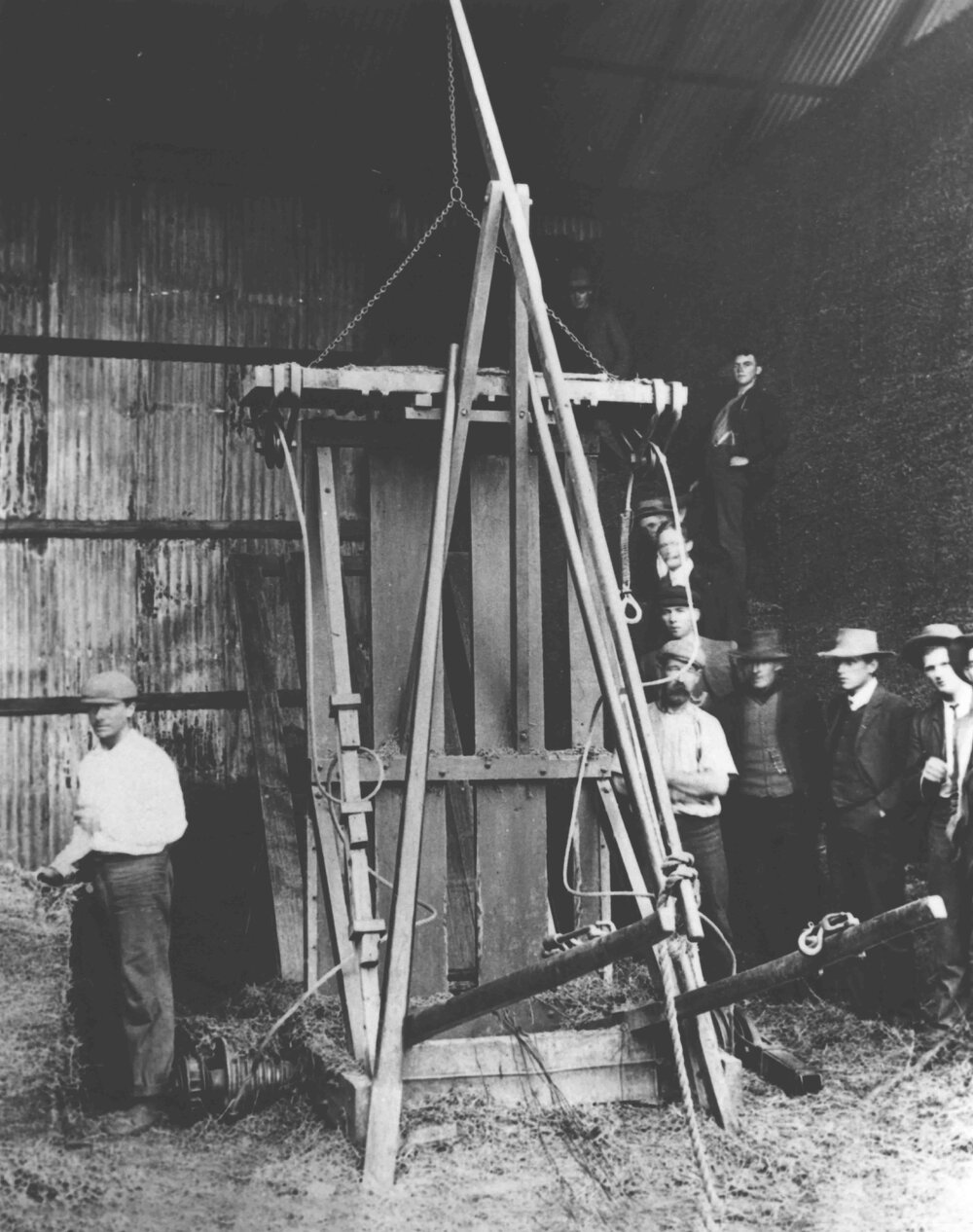 Press for making hay bales - staff &amp; students standing around [Hawkesbury Agricultural College (HAC)]