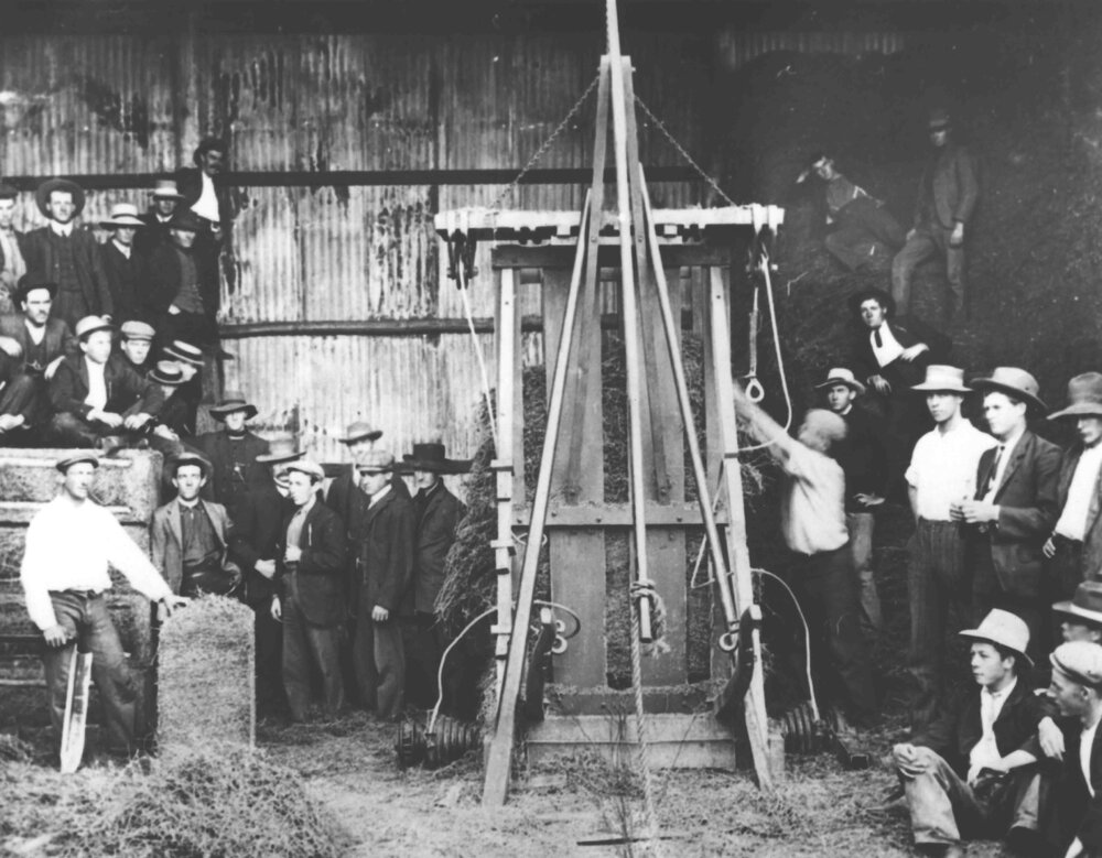 Press for making hay bales - staff &amp; students standing around [Hawkesbury Agricultural College (HAC)]