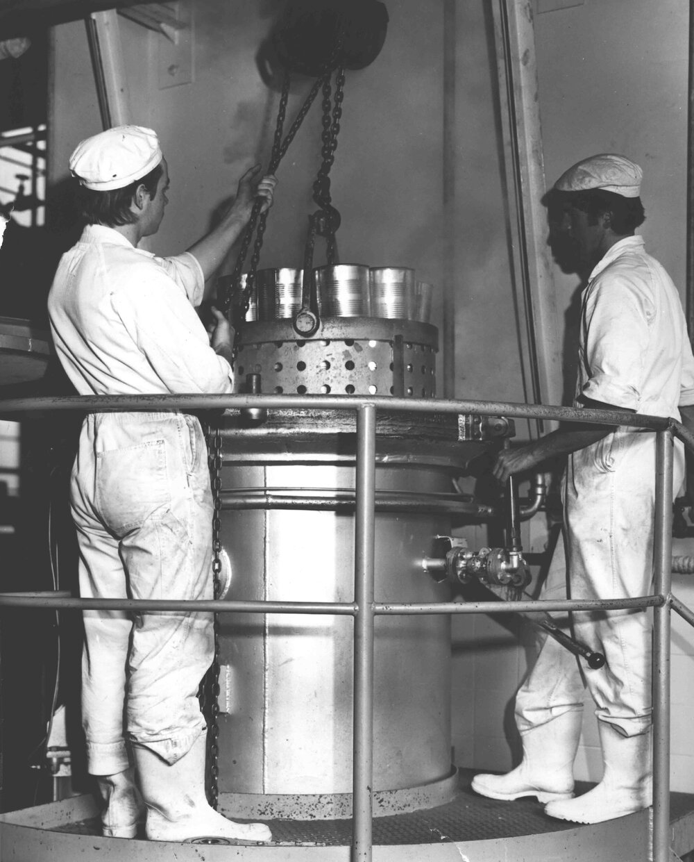 Cannery: Students lowering a retort crate of canned produce into the steam retort [Hawkesbury Agricultural College (HAC)]