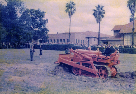 Olympic Swimming Pool - Construction (print 01 of 18) - Mr Roger B Nott, Minister for Agriculture and Food Production, turning the first sod for the new pool (driving the college bulldozer) [Hawkesbury Agricultural College (HAC)]