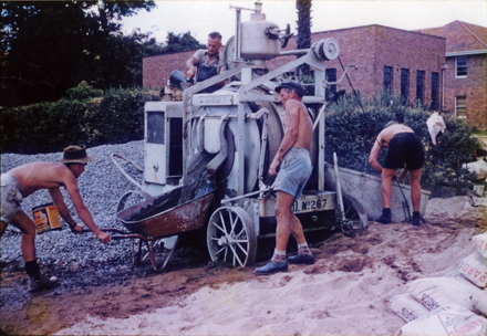 Olympic Swimming Pool - Construction (print 08 of 18) - Working the concreting machine and filling a wheelbarrow with concrete [Hawkesbury Agricultural College (HAC)]