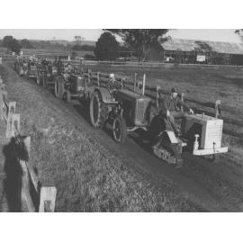 Tractors (7) assembled in a tractor parade along a dirt road [Hawkesbury Agricultural College (HAC)]