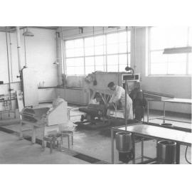 Cannery Building (interior): Two students in overalls working on machinery [Hawkesbury Agricultural College (HAC)]