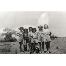 Women's Land Army: Faming activities (print 06 of 12) - Six women standing, one kneeling in a field [Hawkesbury Agricultural College (HAC)]