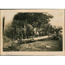 Large canoe full of people pulled up on the beach - Cassia Village (near Hoskins Airfield, New Britain Island, Papua New Guinea)