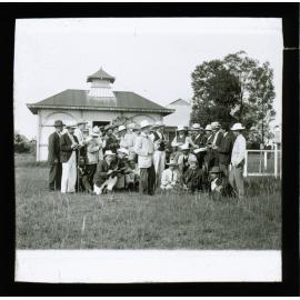 Charles Musson & class in a paddock, unidentified building in background [Hawkesbury Agricultural College (HAC)]