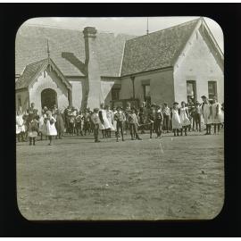Children gathered in front of unidentified school building [Hawkesbury Agricultural College (HAC)]