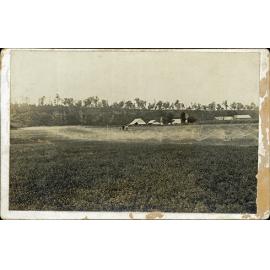 Irrigation spray on the River Farm - farm buildings in background and three men watching [Hawkesbury Agricultural College (HAC)]