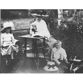 Mrs Potts (wife of the Principal) and two children (a girl and a boy) - pouring tea [Hawkesbury Agricultural College (HAC)]