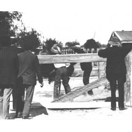 Students catching an ostrich in a yard while the others look on [Hawkesbury Agricultural College (HAC)]