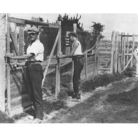 Students closing wire gates to fenced ostrich pens(?) [Hawkesbury Agricultural College (HAC)]