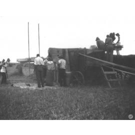 Students under instruction at a grain thresher - loading and bagging [Hawkesbury Agricultural College (HAC)]