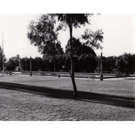Olympic Swimming Pool - Eucalyptus tree in foreground, lamp posts and seats around the pool, and diving platform at the far end [Hawkesbury Agricultural College (HAC)]