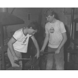 Blacksmith Shop (interior) - Two students working at an anvil [Hawkesbury Agricultural College (HAC)]