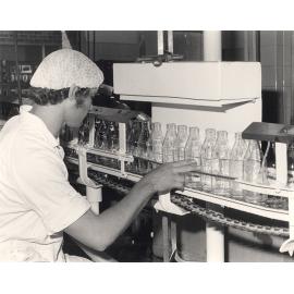Dairy Factory (interior): student checking clean milk bottles (Print 1 of 2) [Hawkesbury Agricultural College (HAC)]