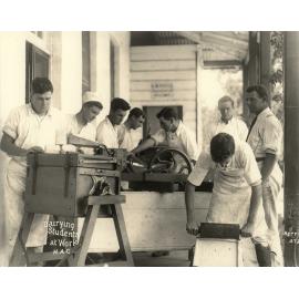 Dairy Factory (exterior): A posed photo of dairy students making butter under supervision on verandah of dairy factory (Print 2 of 2) - Cropped [Hawkesbury Agricultural College (HAC)]